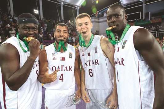 (From left) Qatar players Tanguy Ngombo, Abdulrahman Saad, Nedim Muslic and Erfan Saeed celebrate their gold medal after they beat Iraq in the 3x3 Basketball final at the 5th Asian Indoor and Martial Arts Games in Ashgabat, Turkmenistan, yesterday. (Laurel International Management)