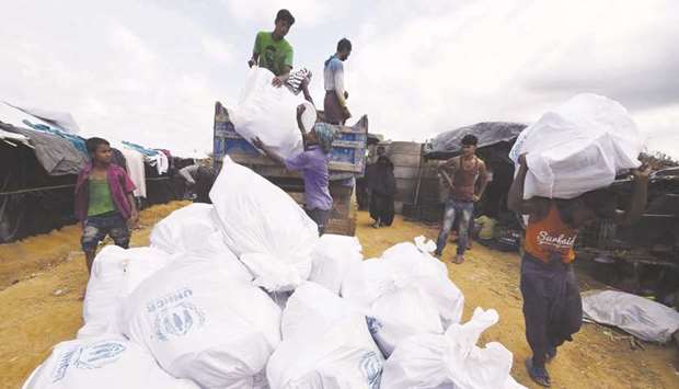 Rohingya refugees receive UN relief supplies at the Kutupalong refugee camp in Bangladesh.