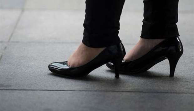 An office worker is seen wearing high-heeled shoes in Makati, Manila's financial district, on Monday.