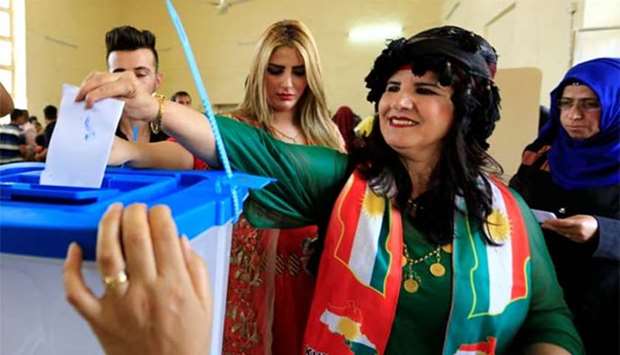 A woman casts her vote at a polling station during referendum, in Kirkuk on Monday.