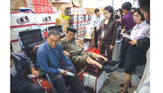 North Korean visitors at a Chinese booth at the 13th International Trade Fair in Pyongyang yesterday. Most of the Chinese firms were traders bringing cooking implements and domestic appliances to sell to retail buyers, rather than manufacturers looking for long-term deals or state-owned enterprises promoting infrastructure projects.