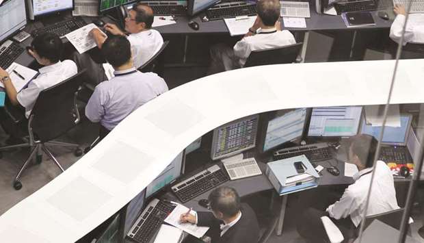 Employees work at the Tokyo Stock Exchange. The Nikkei 225 closed up 0.5% to 20,397.58 points yesterday.