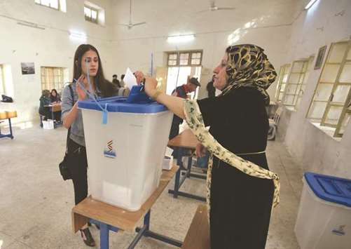 An Iraqi Kurdish woman casts her vote in the Kurdish independence referendum in the city of Kirkuk yesterday.