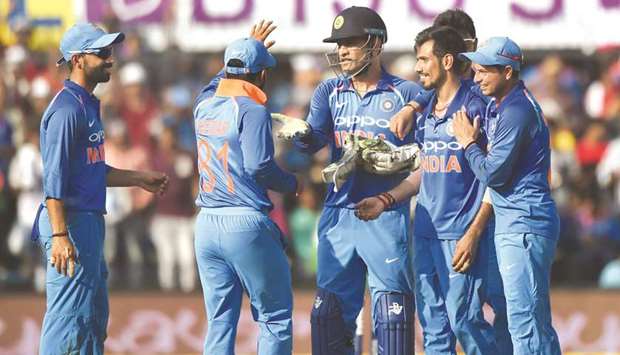 Indian teammates celebrate the wicket of Australiau2019s Glenn Maxwell during the third one-day international at the Holkar Stadium in Indore. (AFP)