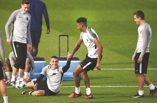 Paris Saint-Germainu2019s Presnel Kimpembe (second right)  jokes with teammate Marco Verratti during training in Saint-Germain-en-Laye, west of Paris, yesterday. (AFP)