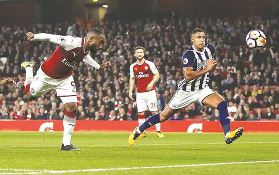 Arsenalu2019s Alexandre Lacazette (left) scores his teamu2019s first goal during the English Premier League match against West Bromwich Albion at the Emirates Stadium in London on Monday night. Thanks to Lacazette's brace won 2-0. (AFP)