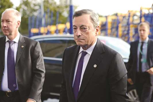 ECB president Mario Draghi (right) arrives for the Eurogroup meeting in Tallinn, Estonia, on September 15. The Single Supervisory Mechanism may front-load stress tests for Greek banks, Draghi said on Monday.