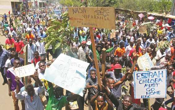 Supporters of the opposition National Super Alliance coalition chant slogans during a  demonstration calling for the removal of Independent Electoral and Boundaries Commission officials in Kisumu, Kenya.