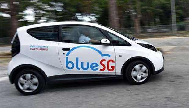 A staff member test driving an electric Bluecar in Singapore.