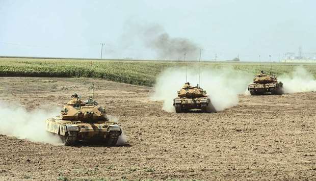 Tanks move during a Turkish and Iraqi joint military exercise near the border at Silopi district in Sirnak yesterday.