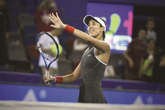 Garbine Muguruza of Spain celebrates after defeating against Magda Linette of Poland during their third round match at the WTA Wuhan Open in  Wuhan yesterday. (AFP)