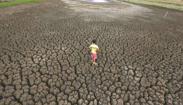 Natan Cabral, 5, stands on the cracked ground of the Boqueirao reservoir in the Metropolitan Region of Campina Grande, Paraiba state, Brazil, February 13, 2017.
