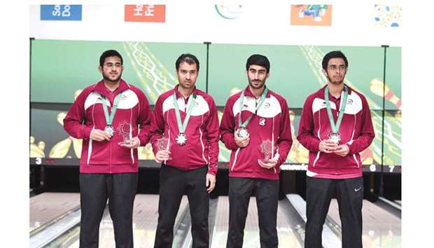 Qatar bowling team of Ghanim Mohamed Aboujassoum (left), Yousef Abdulrahman al-Jabir (second from left) Saoud Ahmad Abdulla and Jassim al-Muraikhi (right) pose with their silver medals on menu2019s Teams of Four podium at the Asian Indoor and Martial Arts Games in Ashgabat, Turkmenistan, yesterday. (Laurel)