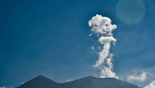 Mount Agung volcano spews smoke as seen from Karangasem, on the island of Bali, on Thursday.