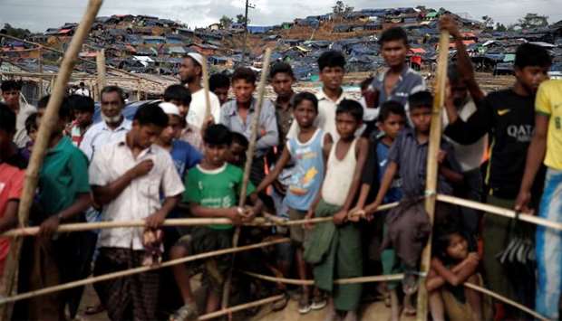 Rohingya refugees queue for aid at a camp in Cox's Bazar, Bangladesh