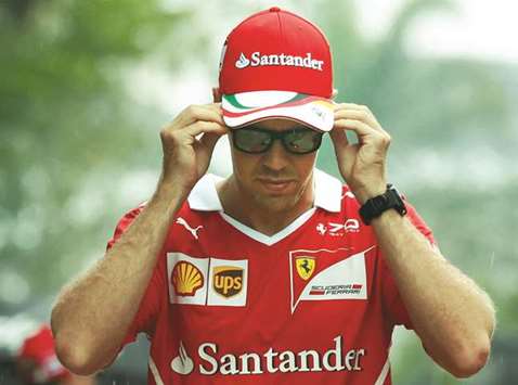 Ferrariu2019s Sebastian Vettel arrives in the paddock yesterday. (Reuters)