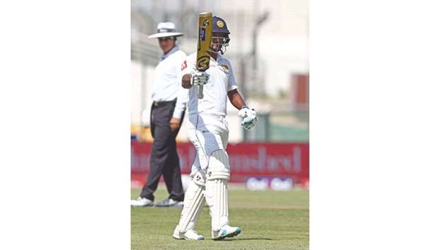 Dimuth Karunaratne of Sri Lanka celebrates after his half century on the day one the first Test against Pakistan yesterday. (AFP)