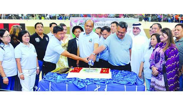 PSD officials led by board of trustees chairman Gerardo P Macasa Jr officiate the cake-cutting ceremony. Looking on are Ali al-Maki of Al Rayyan Sports Club and other guests. PICTURE: Ram Chand