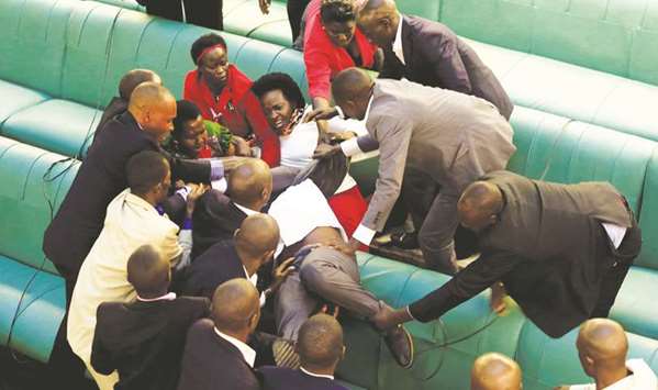 Ugandan opposition lawmakers fight with plain-clothes security personnel in parliament on Thursday while protesting a proposed age limit amendment bill debate.