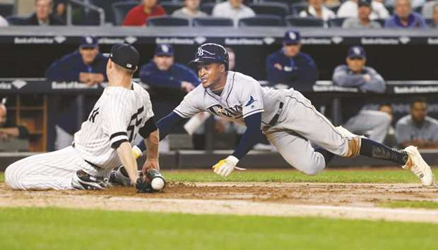 Tampa Bay Raysu2019 Mallex Smith (right) scores on a passed ball by New York Yankeesu2019 Sonny Gray in the fifth during their MLB game at Yankee Stadium in Bronx, New York, on Thursday. (USA TODAY Sports)