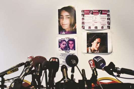 A picture taken in Villeurbanne, eastern France, on Thursday night before a press conference of the lawyers and parents of missing nine-year-old Maelys shows microphones installed in front of pictures of the missing child.
