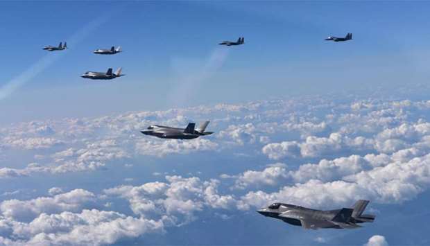 US Marine Corps F-35B fighter jets and South Korean air Force's F-15K fly over South Korea during a joint military drill