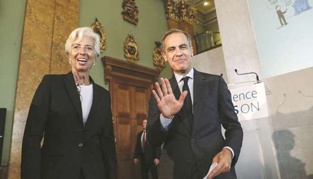 IMF managing director Christine Lagarde (left) and BoE governor Mark Carney react during the BoEu2019s u2018Independence u2014 20 Years Onu2019 conference at Fishmongersu2019 Hall in the City of London yesterday. Carney said yesterday the economy was on track for a rate hike u201cin the relatively near term.u201d