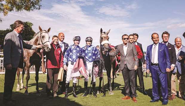 His Highness Sheikh Mohamed bin Khalifa al-Thani leads in Rajeh after Francois-Xavier Bertras rode the colt to victory in Qatar Arabian Trophy des Poulains (Gr1 PA) at Saint-Cloud yesterday. (Below) Sheikh Mohamed (left) receives the trophy after Rajehu2019s victory. PICTURES: Juhaim