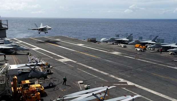An F/A-18 Super Hornet lands on the deck of the USS Ronald Reagan in the South China Sea