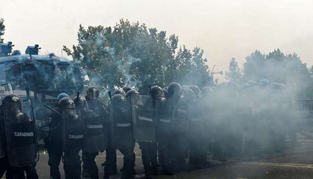 Police block a road during a demonstration against the G7 summit of Labour Ministers in Turin.