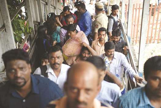 Pedestrians walk past the scene of a stampede on a railway bridge in Mumbai.