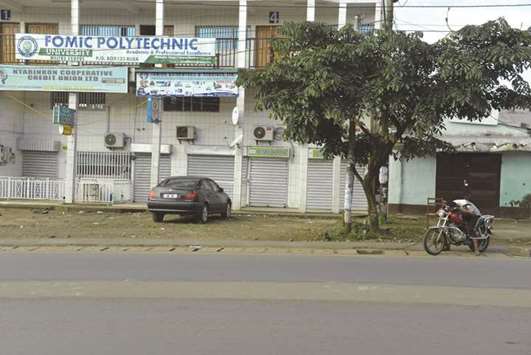 A man rides his motorcycle in an empty street by closed shops in Buea, the capital of the anglophone southern region of Cameroon yesterday. Anticipating unrest, officials in the south west have imposed a three-day closure of land and sea borders, suspended transport and banned gatherings ahead of what is expected to be a symbolic declaration of independence today by Cameroonu2019s English speakers who make up a fifth of the population.