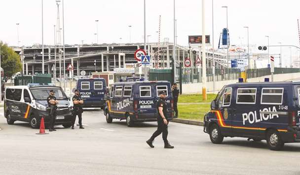 Spanish national police vehicles enter the port, where hundreds of Spanish national police and civil guard reinforcements are housed in two ferries a day before the banned October 1 independence referendum, in Barcelona yesterday.