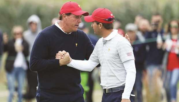 Phil Mickelson and Kevin Kisner of the US Team celebrate after they defeated Emiliano Grillo and Jhonattan Vegas of the International Team in the foursome matches of the Presidents Cup in Jersey City, New Jersey, yesterday. (AFP)