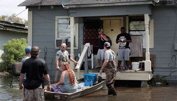 Members of the Wounded Veterans of Oklahoma help rescue flood victims after torrential rains pounded southeast Texas.