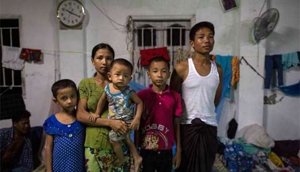 Nin Oo Khaing (second left) poses for a portrait with family members at an internally displaced persons camp in Sittwe.