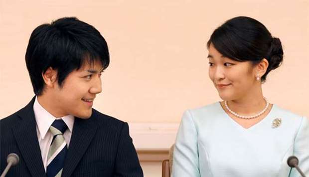 Princess Mako and her fiancee Kei Komuro smile during a press conference to announce their engagement in Tokyo on Sunday. 