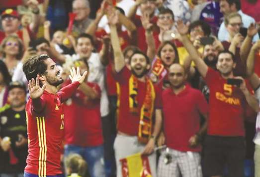 Spainu2019s midfielder Isco celebrates after scoring a goal against Italy in the World Cup 2018 qualifier at the Santiago Bernabeu stadium in Madrid. (AFP)