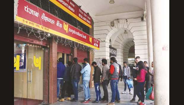 People queue up outside an ATM kiosk to withdraw cash on the last day of demonetisation in New Delhi on December 30, 2016: jury is out on whether demonetisation was necessary if only because 99% of the banned currency has been returned to the government.