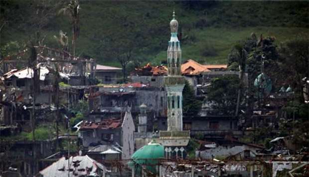 Damaged buildings and houses are seen as government troops continue their assault on its 105th day of clearing operations against pro-IS militants who have seized control of large parts of Marawi city, southern Philippines, on Monday.