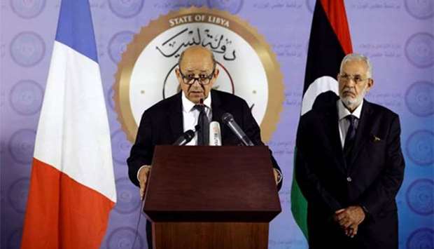 French Foreign Minister Jean-Yves Le Drian (left) speaks during a news conference in Tripoli on Monday.