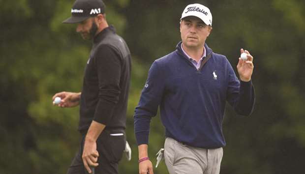 Justin Thomas of the United States (R) acknowledges fans after putting on the 18th green as Dustin Johnson of the United States looks on during round three of the Dell Technologies Championship at TPC Boston on Sunday in Norton, Massachusetts.