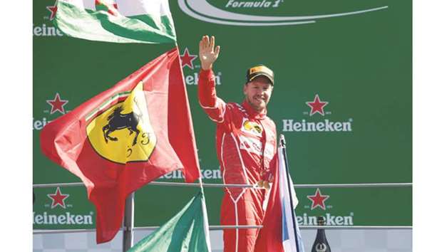 Ferrariu2019s Sebastian Vettel waves to the fans from the podium. (Reuters)