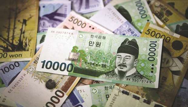 South Korean won banknotes are arranged for a photograph in Seoul. The won sank 0.9% against the dollar yesterday.