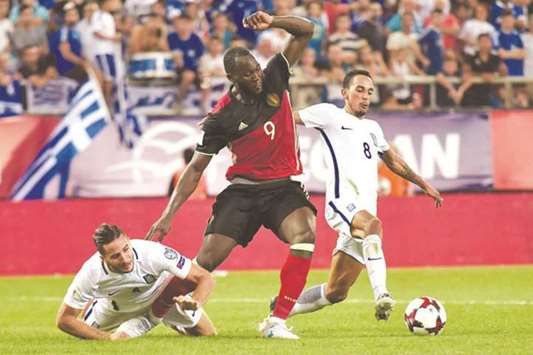 Belgiumu2019s Romelu Lukaku (centre) fights for the ball with Greeceu2019s Zeca (right) and Konstantinos Manolas during the World Cup qualifying match on Sunday. (AFP)