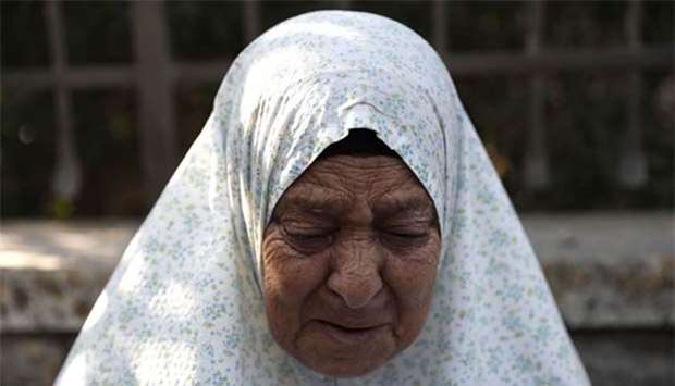 Palestinian Fahamiya Shamasneh, 75, cries as Israeli policemen evict her from her family home, in Sheikh Jarrah in east Jerusalem, on Tuesday,