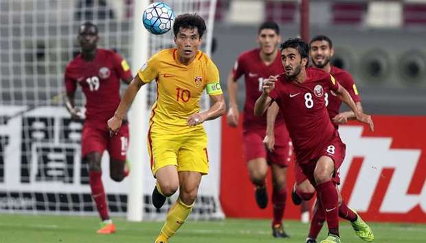 China's Zheng Zhi fights for the ball during the FIFA World Cup 2018 qualification football match between Qatar and China at the Jassim Bin Hamed Stadium in Doha