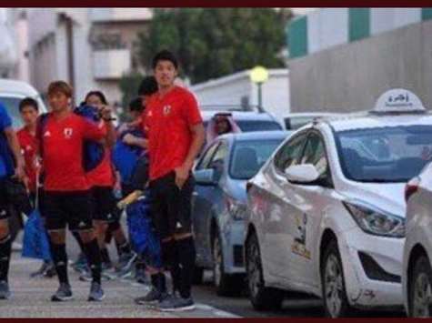 Japanese players wait for taxis outside Jeddah airport.