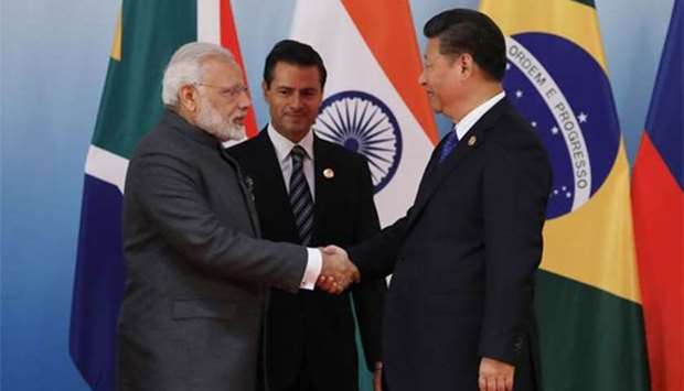 Chinese President Xi Jinping greets Indian Prime Minister Narendra Modi (left) and Mexico's President Enrique Pena Nieto before a group photo session on the sidelines of the 2017 BRICS Summit in Xiamen on Tuesday.