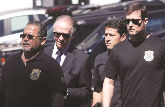 Nuzman being escorted to the Federal Police headquarters in Rio de Janeiro.